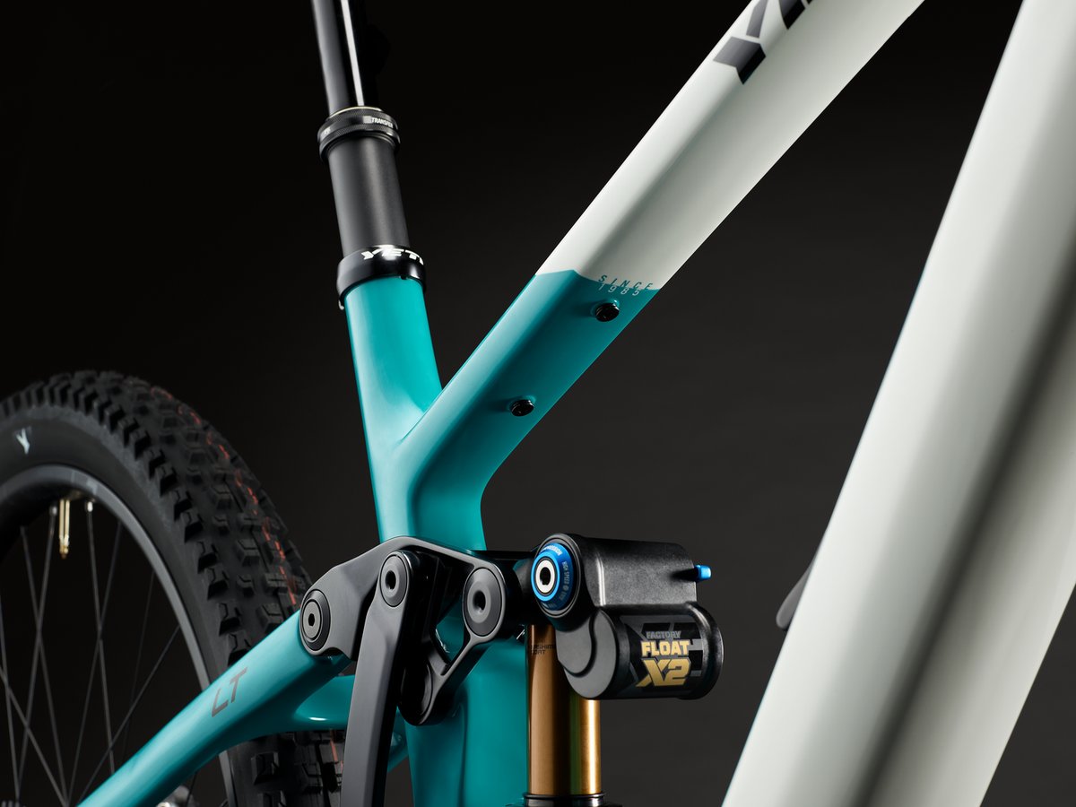 Detail of threaded accessory-mount bosses on the top tube near the seat cluster, with "Since 1985" text visible on the frame.