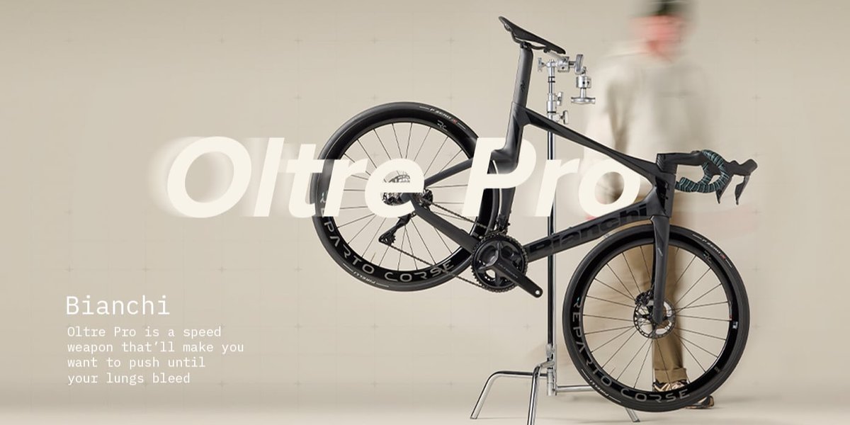 Oltre Pro is a speed weapon that’ll make you want to push until your lungs bleed. A person walks around the bike in a workstand.