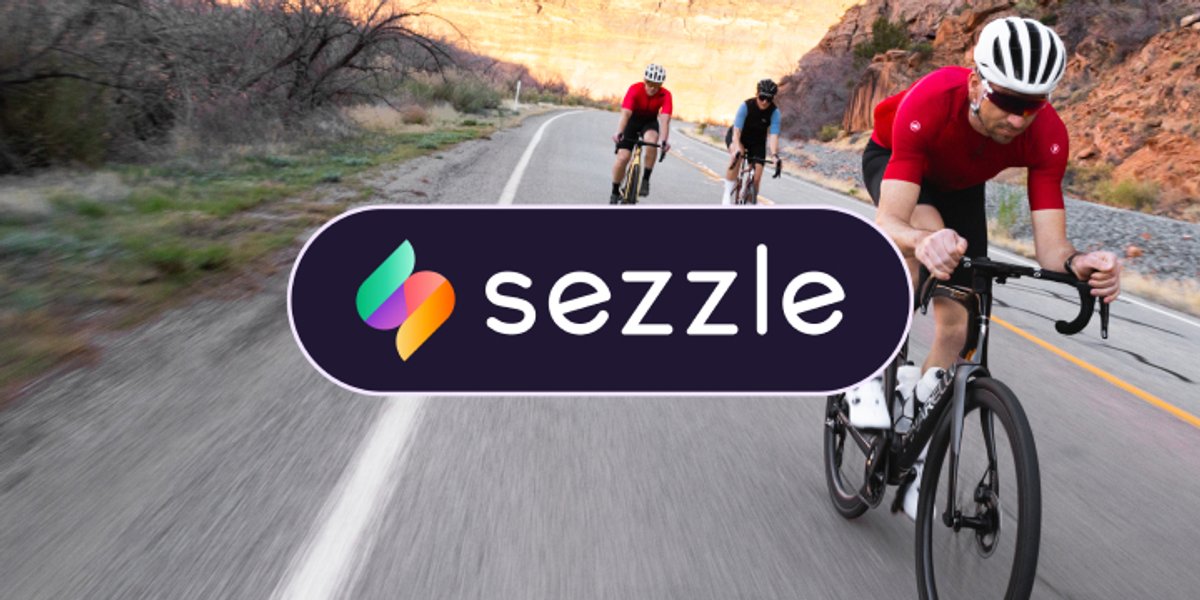 Sezzle logo overlaid on a photo of cyclists riding down a desert road