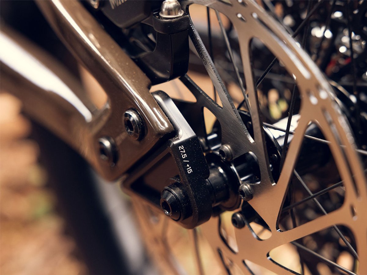 ibis Oso electric mountain bike frame in bronze finish detail of bolt-on dropout part.