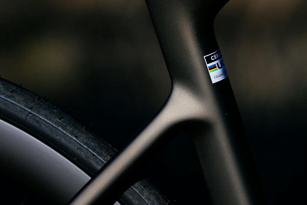Close-up of matte black Cervélo carbon road bike frame fork junction showing UCI approved frameset sticker detail