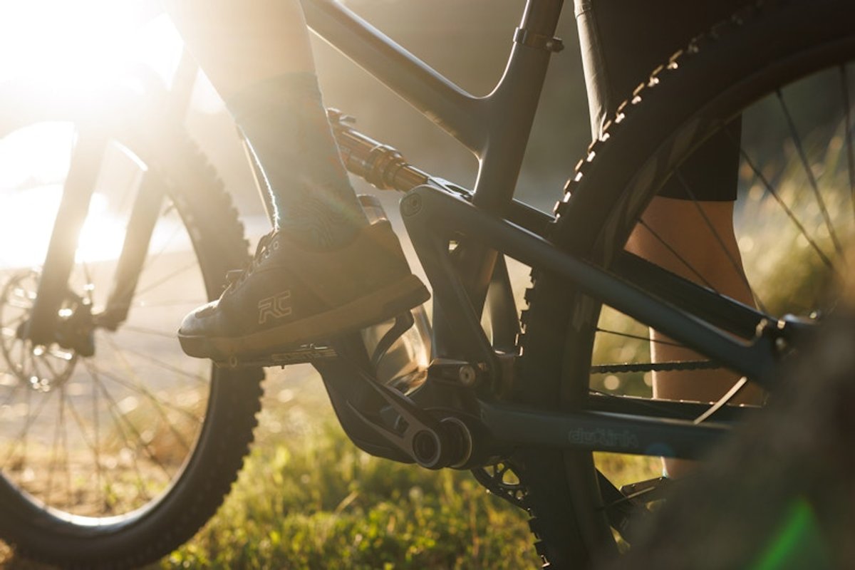 Rider sitting on bike cropped knee down. 