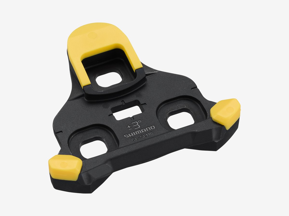 Close-up of a yellow CL-SL110 SPD-SLR cleat, isolated on white background
