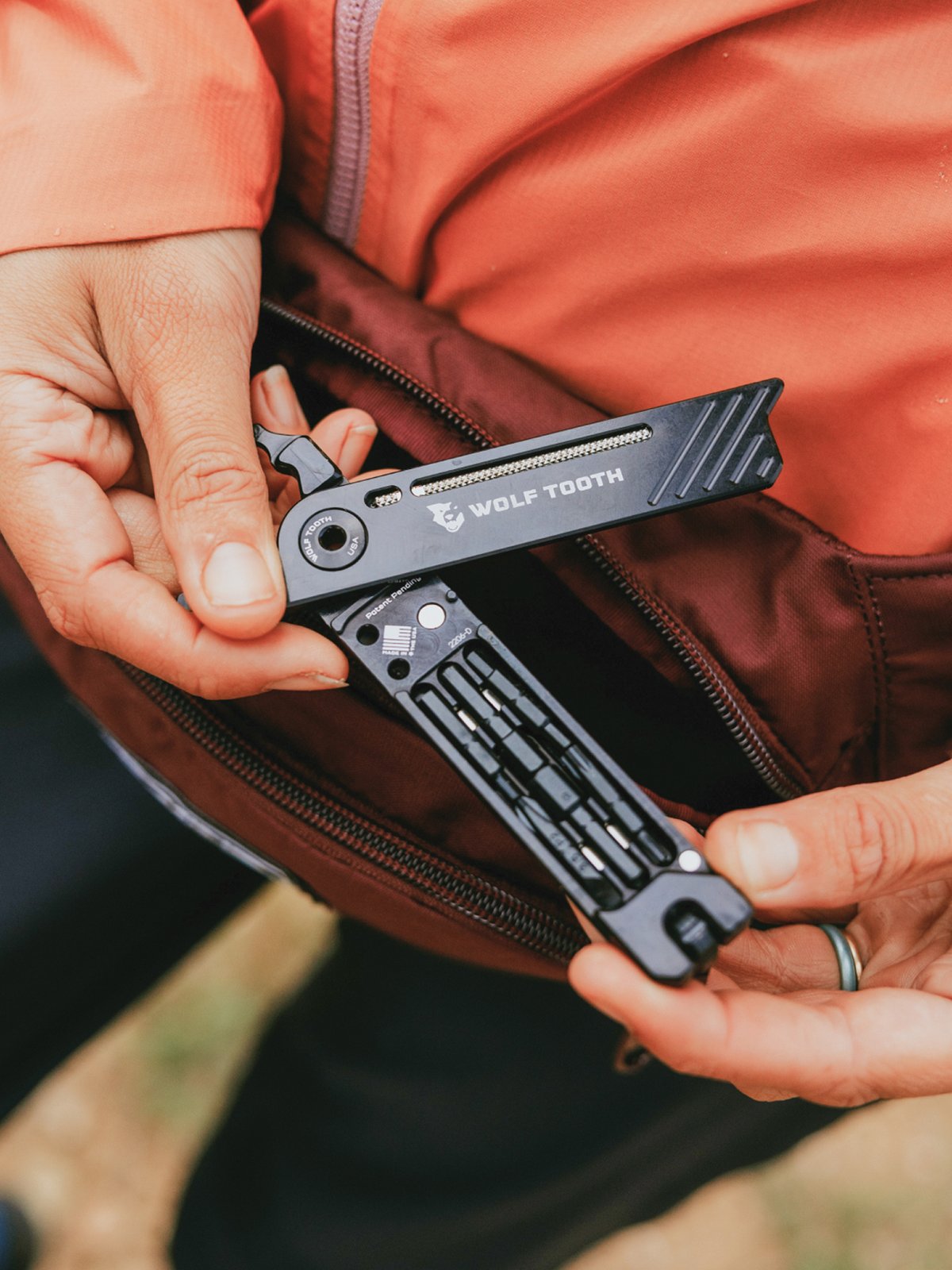 A rider opens a multi-tool.